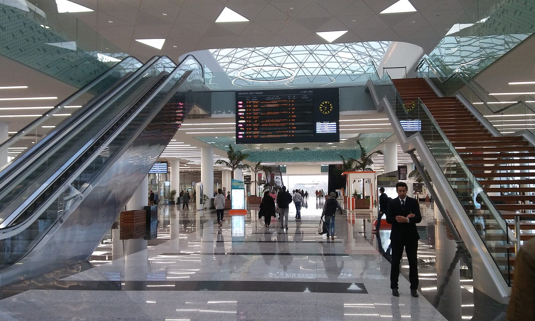 Concourse of Rabat Agdal railway station with escalators and a departures board