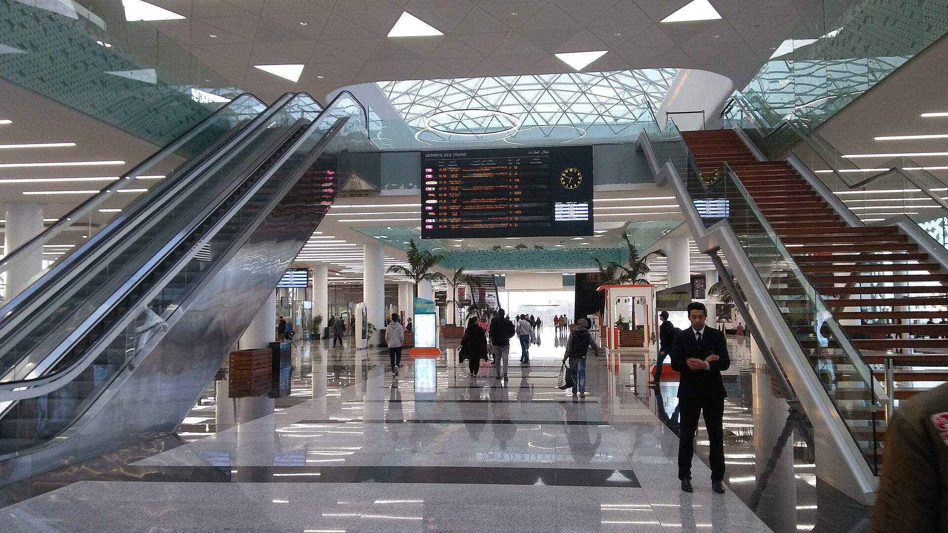 Concourse of Rabat Agdal railway station with escalators and a departures board