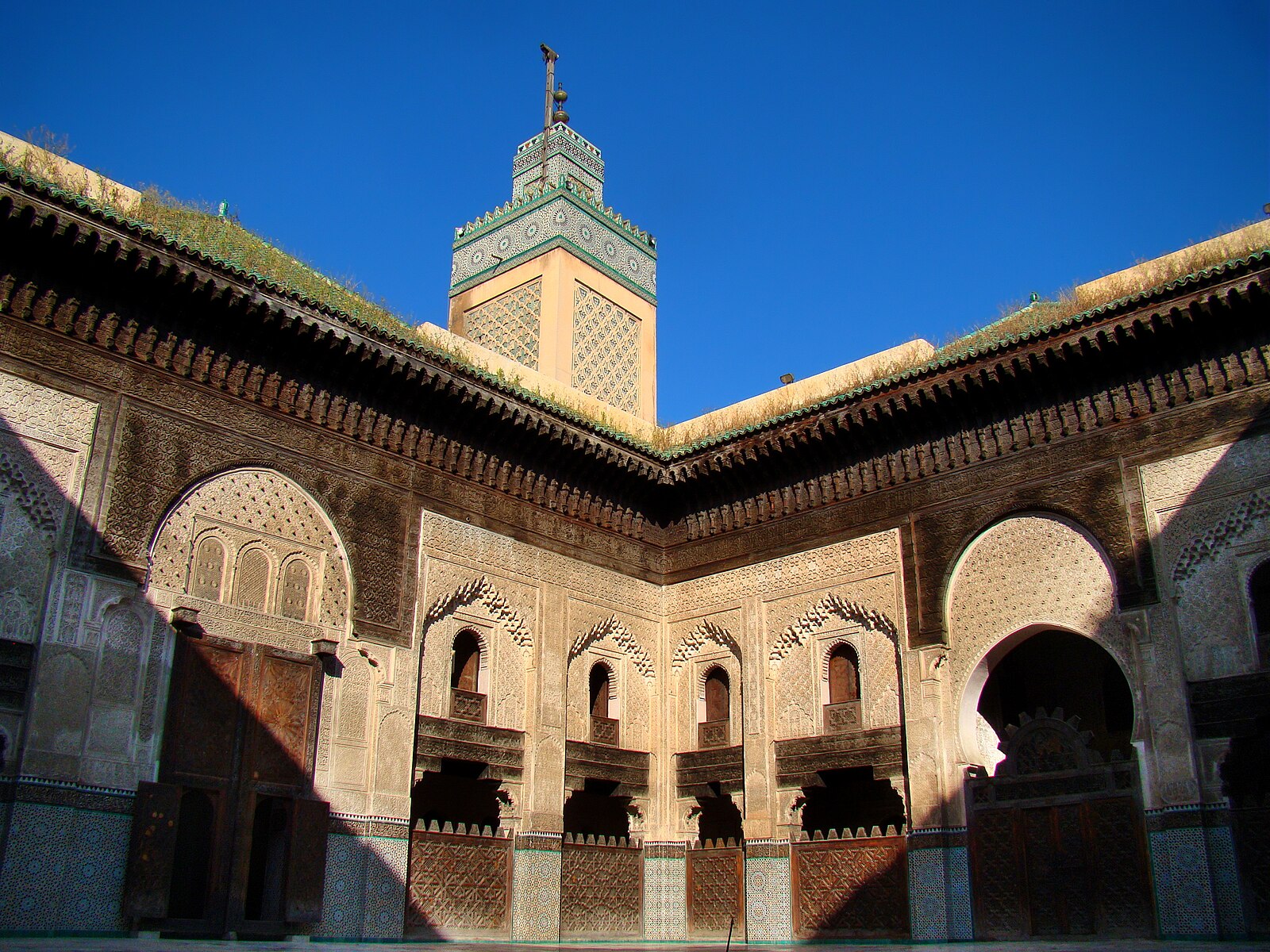 Morocco religion and learning: the courtyard and minaret of the Bou Inania Madrasa in Fez