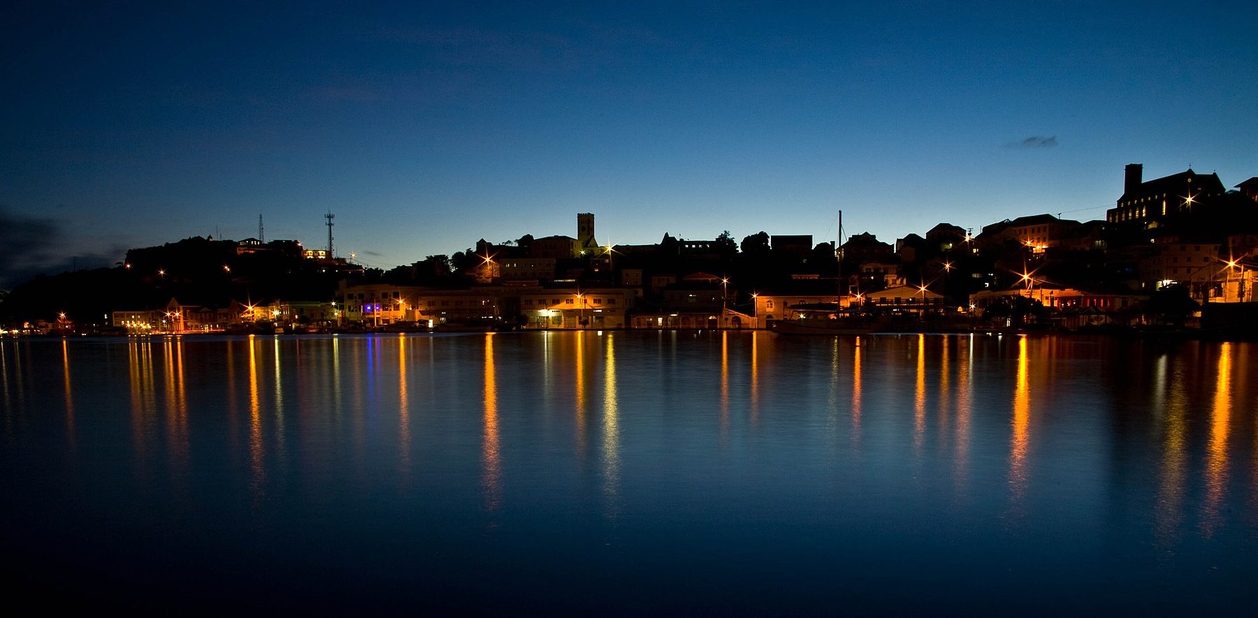 The Carenage harbour in St. George's, Grenada, lit up at dusk