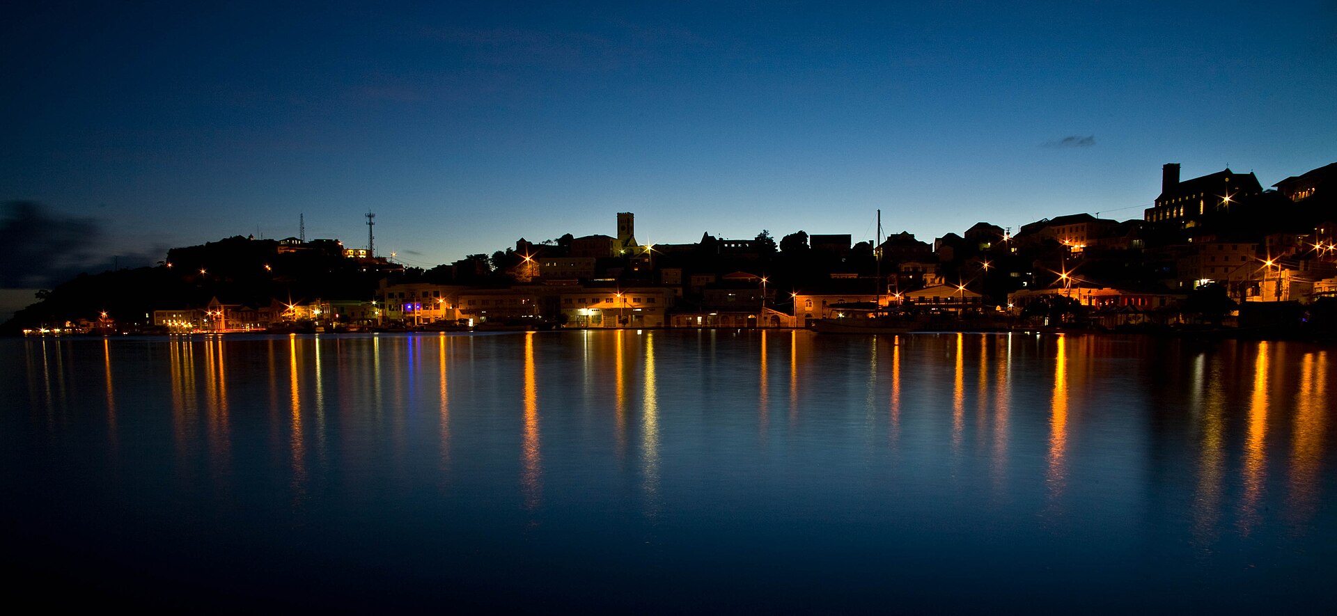 The Carenage harbour in St. George's, Grenada, lit up at dusk