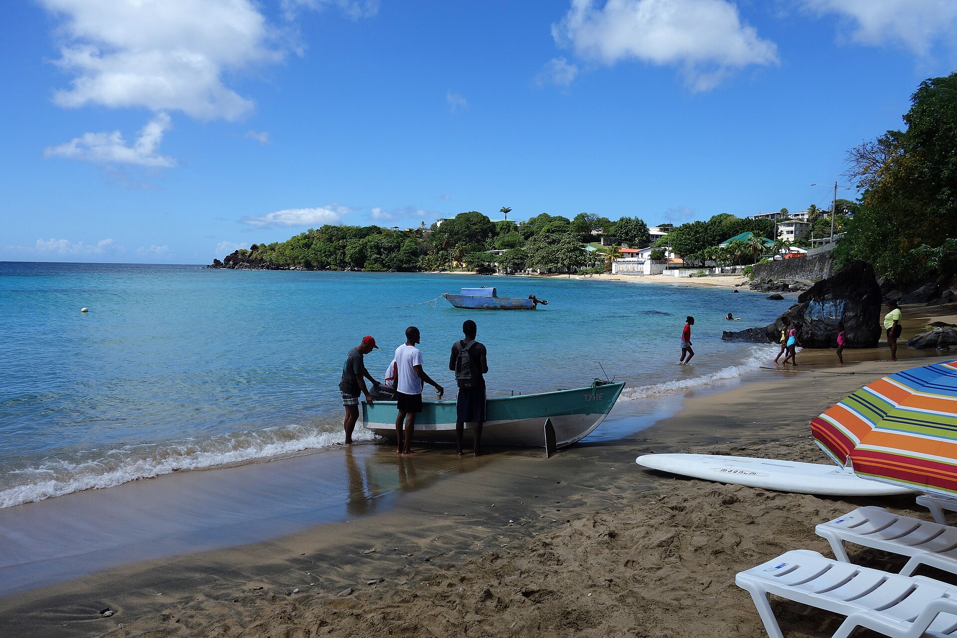 Fishermen pull a boat onto the beach at Indian Bay on Saint Vincent