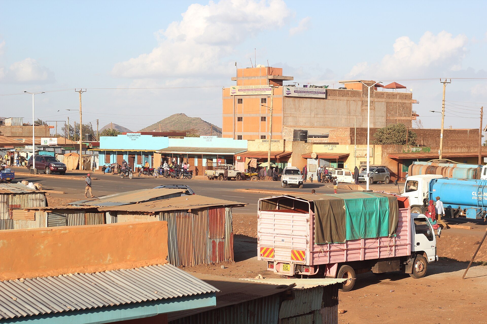 A street in Marsabit town, northern Kenya, with shops, a cargo truck and a water tanker