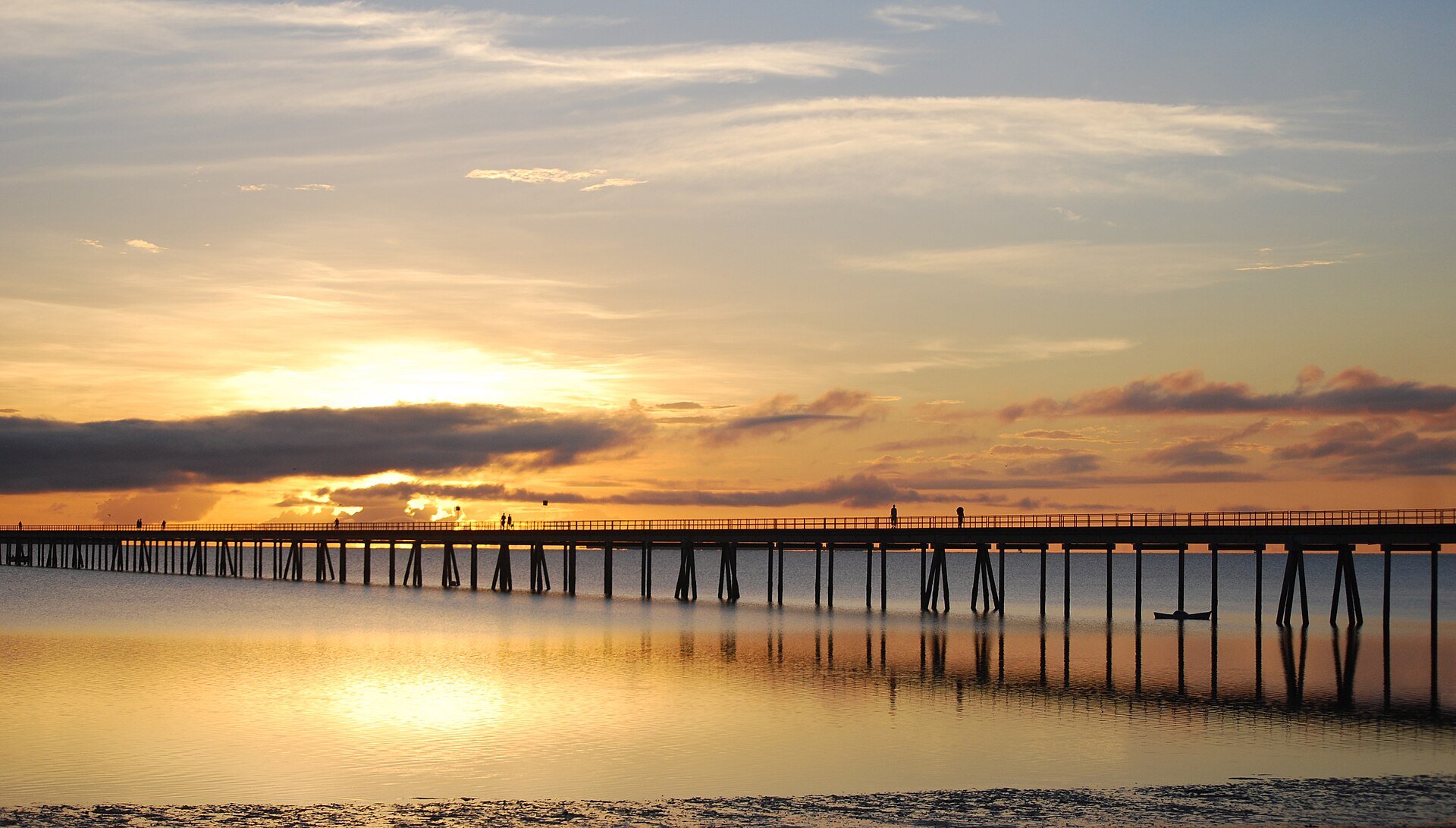 Long bridge over calm water at sunset linking the Island of Mozambique to the mainland
