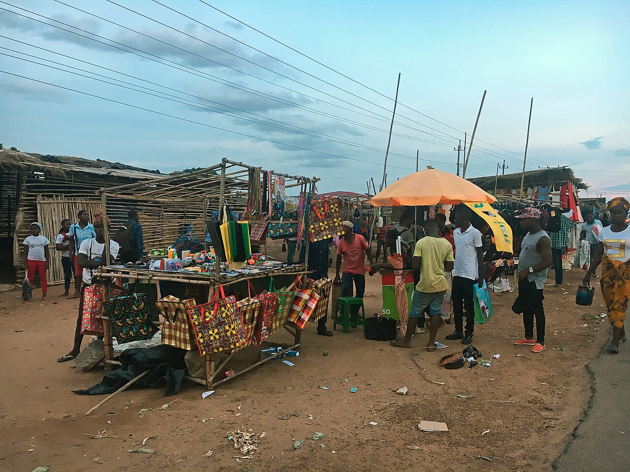 Street vendors selling colourful woven bags and clothes at an open-air stall in Nampula, Mozambique