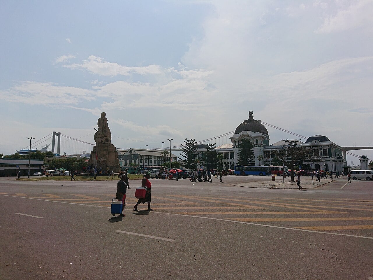 Maputo Railway Station and a monument on Praça dos Trabalhadores, with the Maputo–Katembe suspension bridge in the background