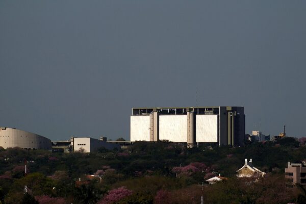 The Banco Central del Paraguay building, a pale concrete block with white panels, above green trees in Asunción