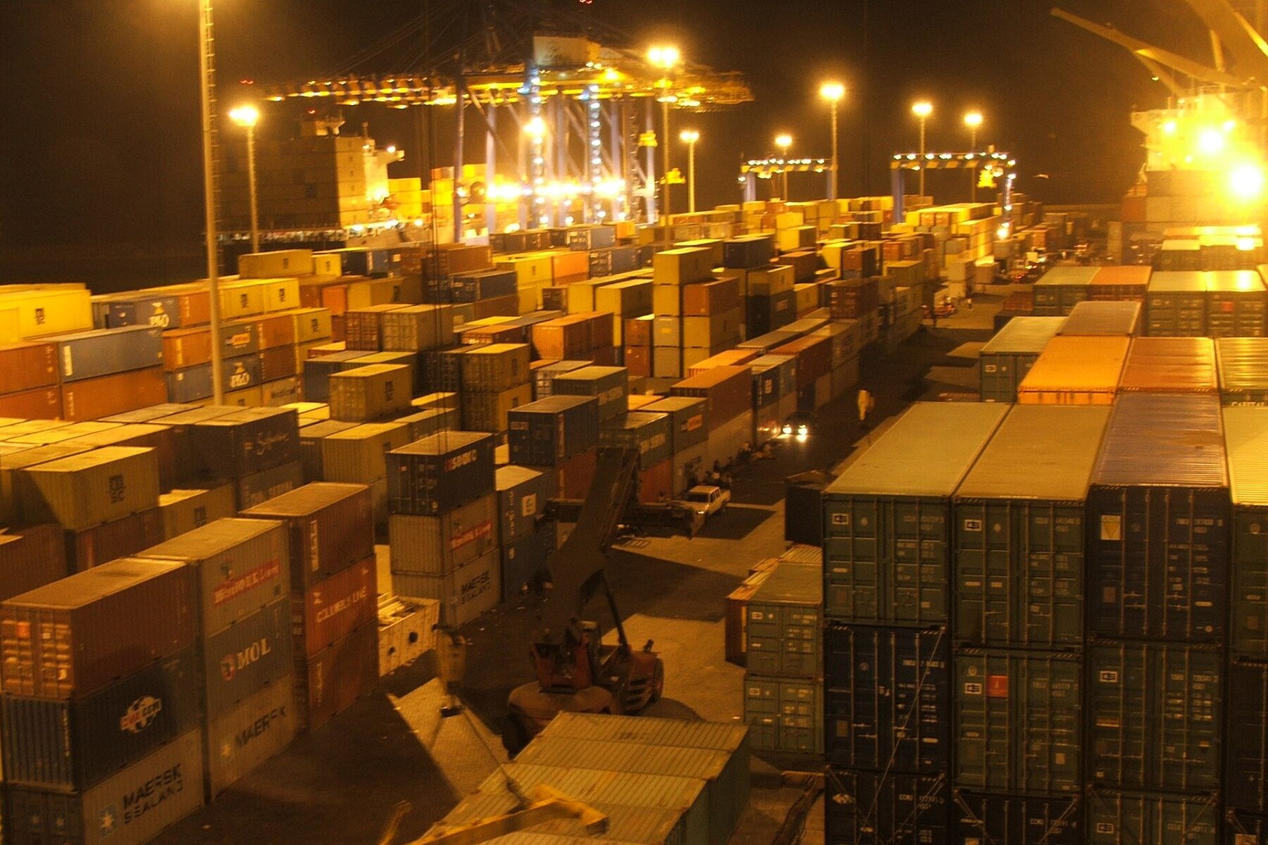 Container stacks and cranes at the port of Tema, Ghana, at night