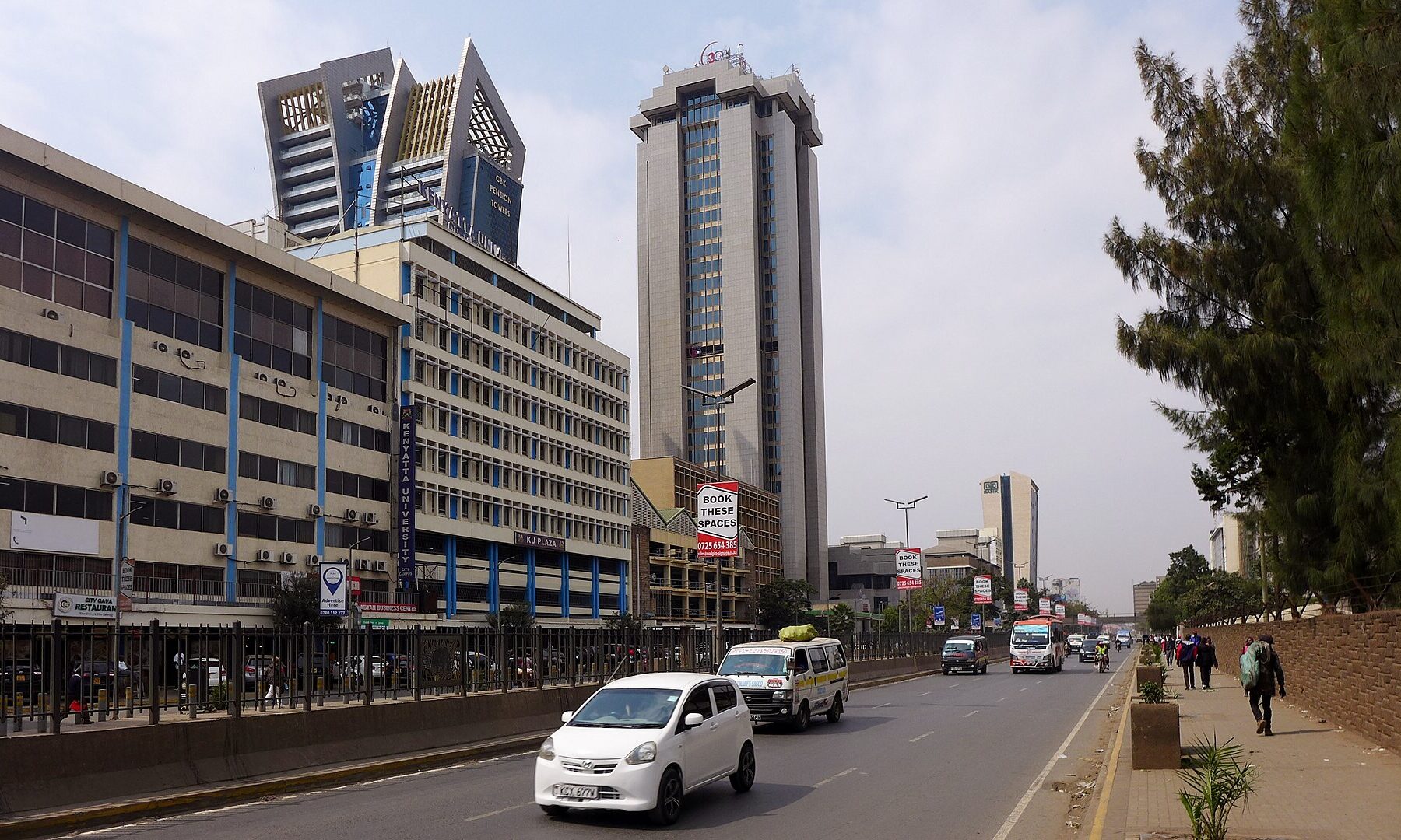 Cars and a white minibus on Haile Selassie Avenue in Nairobi, with the CBK Pension Towers and other office blocks behind