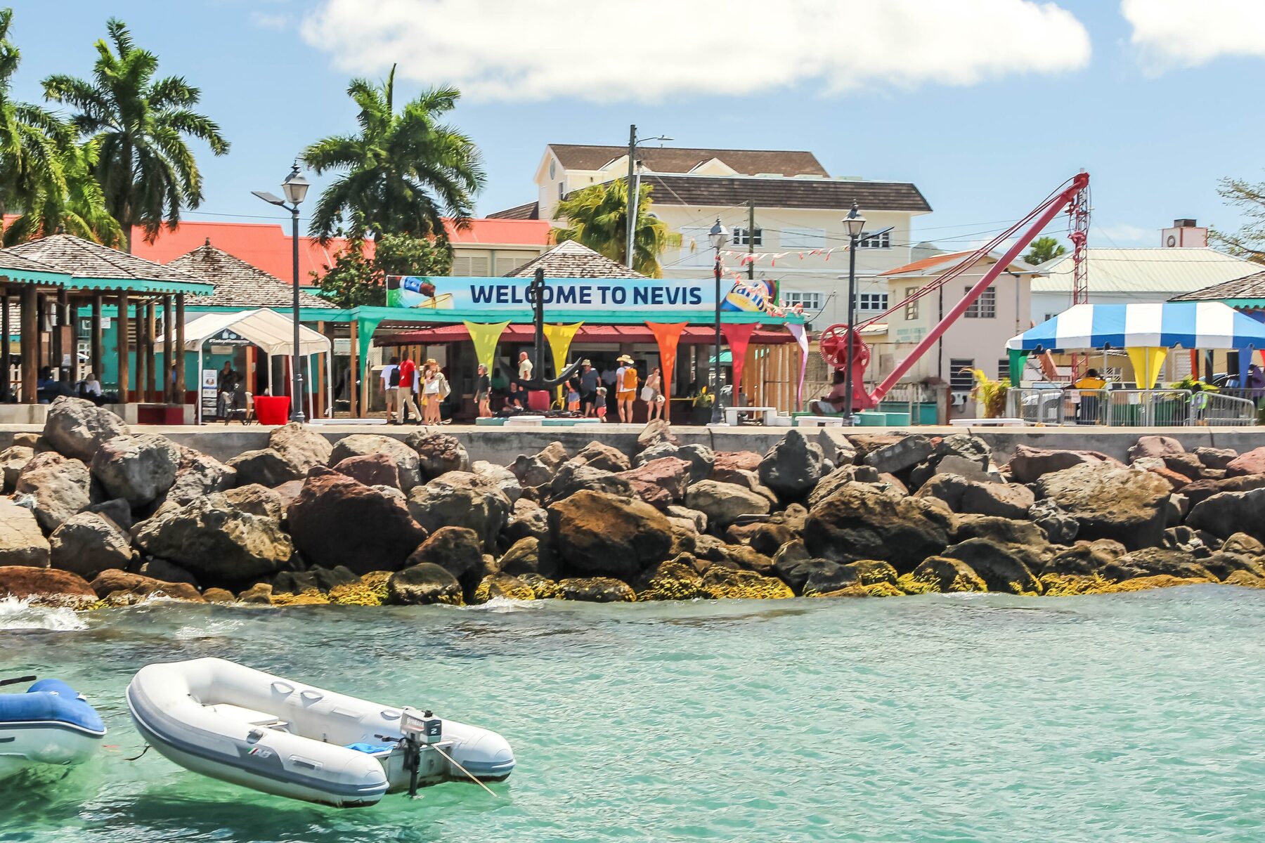 The Charlestown ferry pier on Nevis, with a Welcome to Nevis sign above the waterfront