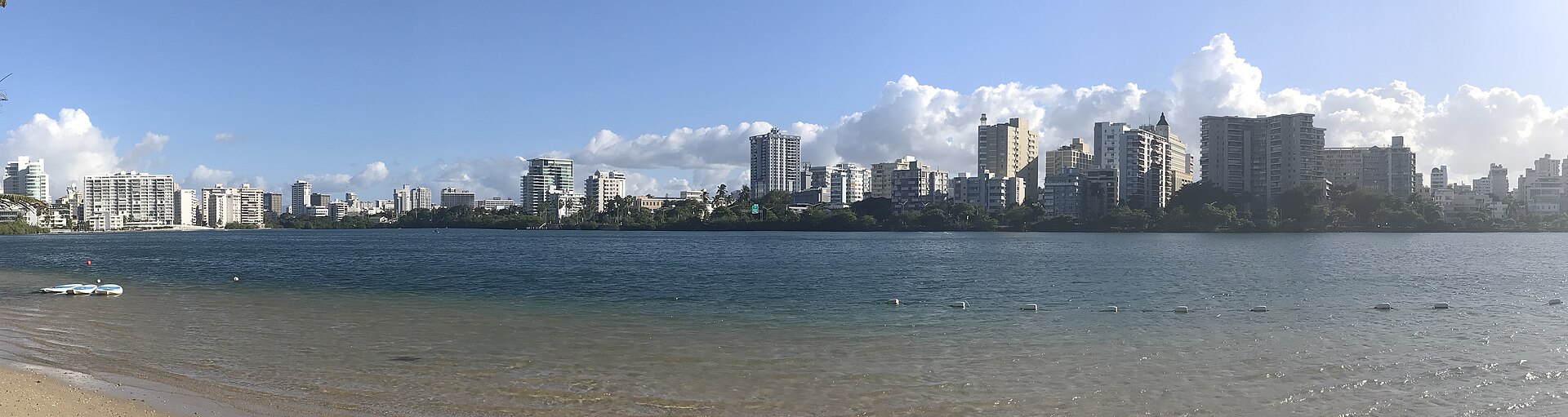 Condado skyline of San Juan, Puerto Rico, seen across the lagoon from Playita Condado under a blue sky
