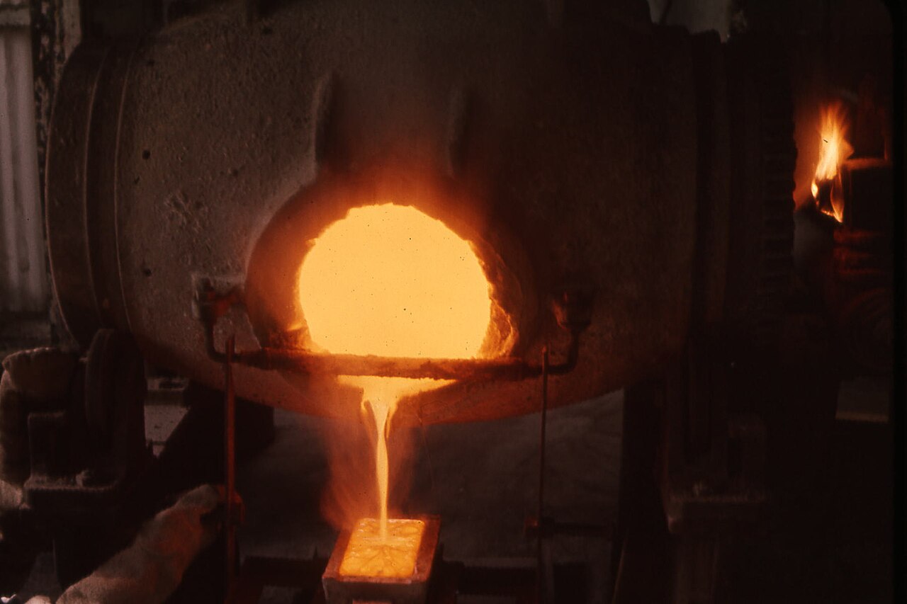 Molten gold pouring from a furnace into an ingot mould, in an old picture from the La Luz mine in Nicaragua.
