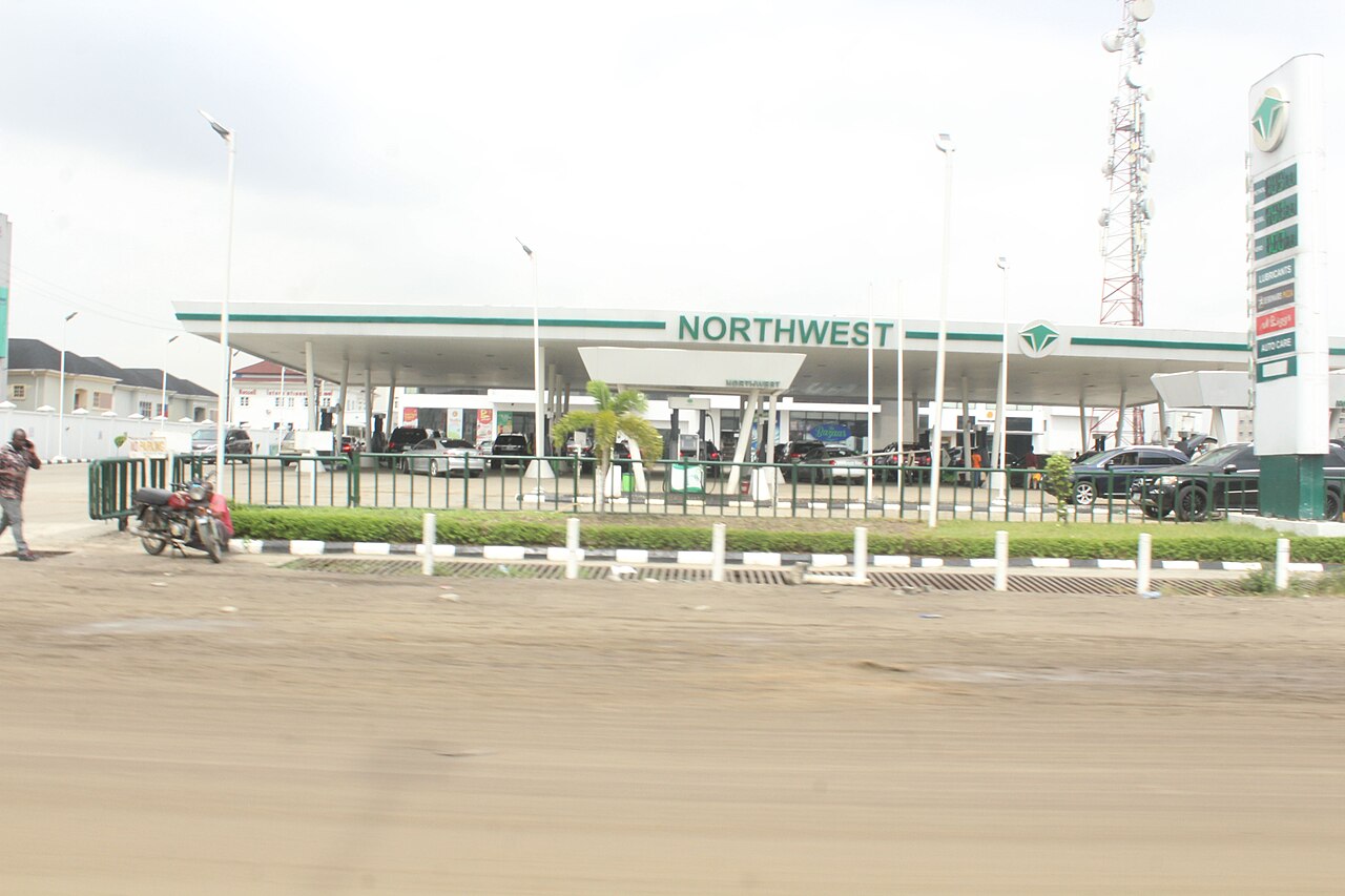 A Northwest filling station with a long white canopy and a tall price sign beside a road in Lekki, Lagos, Nigeria