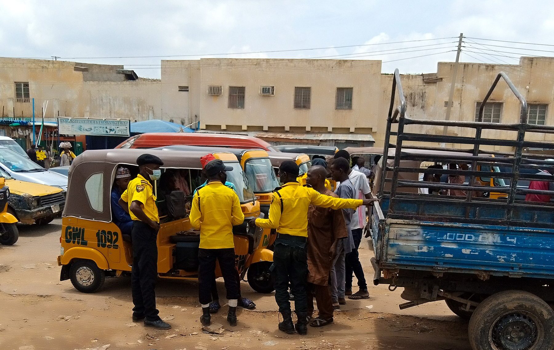 Kano road traffic officers with tricycle taxis in Kano, Nigeria