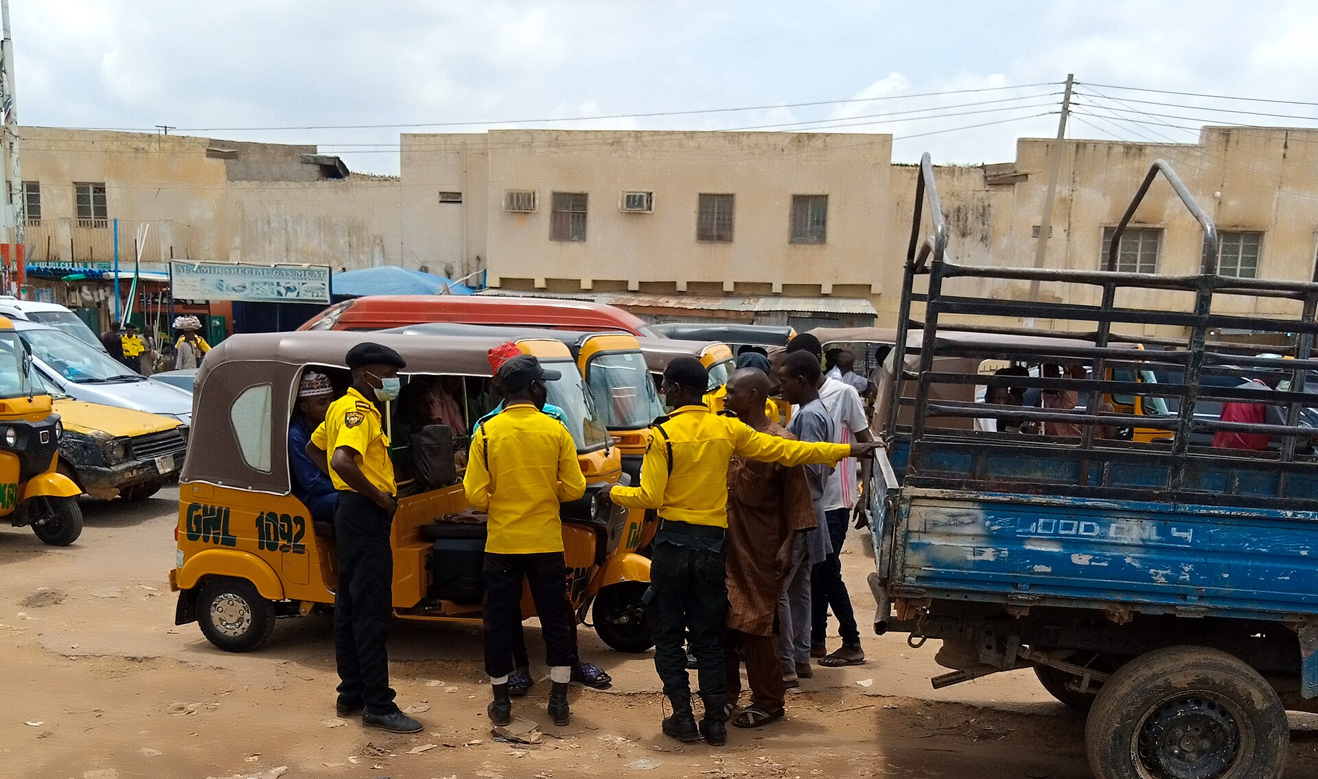 Kano road traffic officers with tricycle taxis in Kano, Nigeria