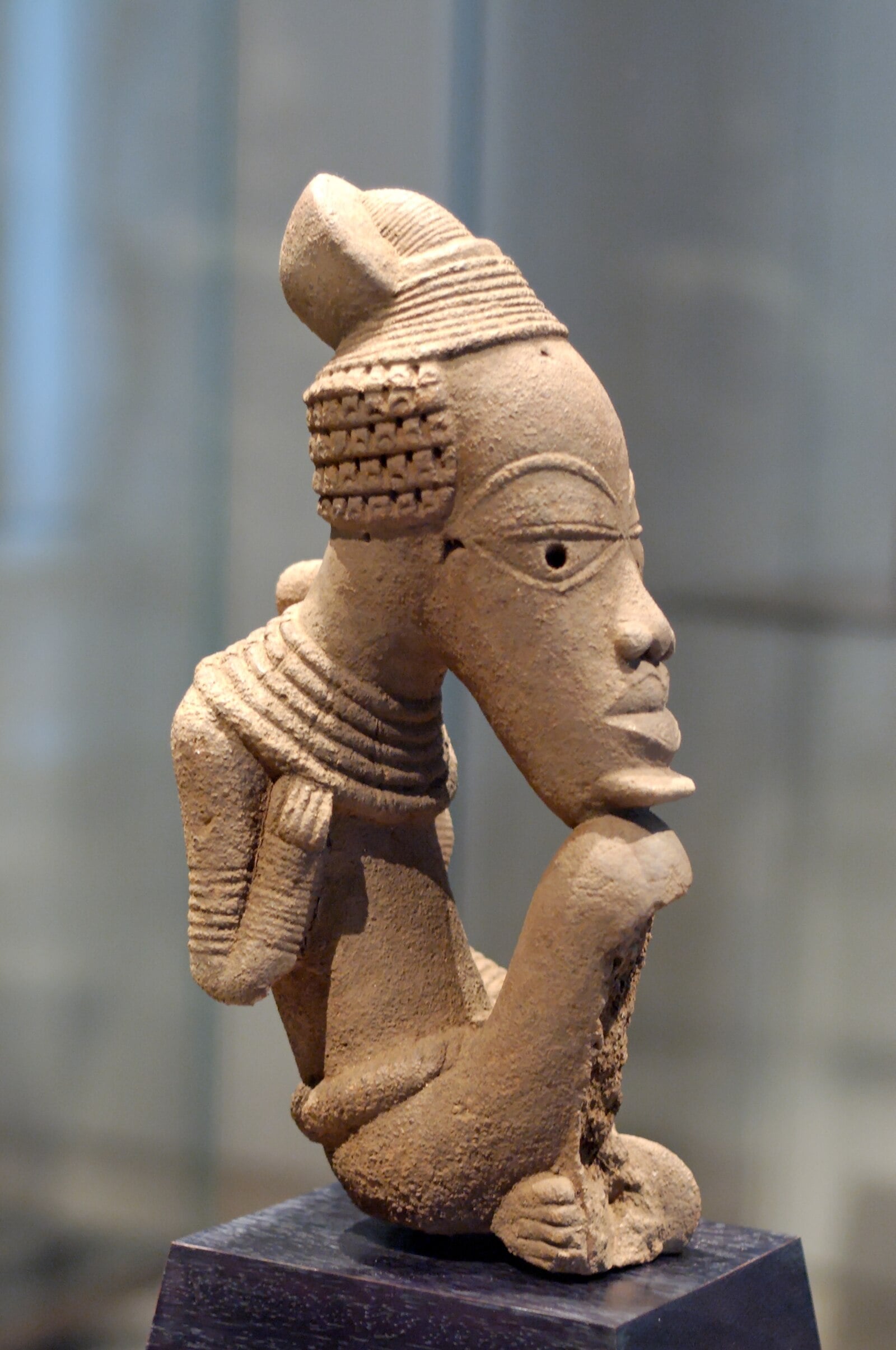 Nigeria history: a seated Nok terracotta figure on display at the Louvre