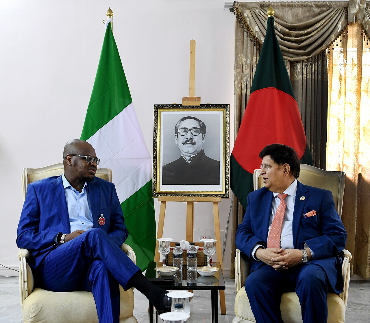 Isa Ali Pantami in a blue suit seated beside Bangladesh's foreign minister, with Nigerian and Bangladeshi flags behind them