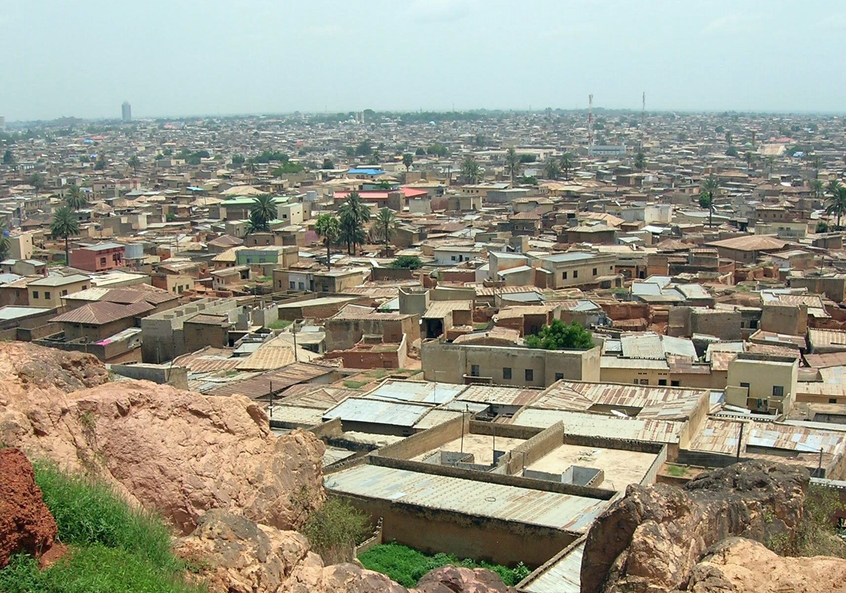 Rooftops of Kano city in northern Nigeria seen from Dala Hill, with mosques and telecom masts on the horizon