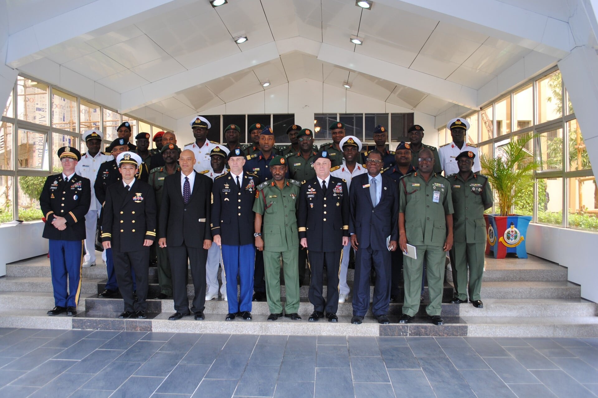 Nigerian and US military officers pose together on the steps of the National Defence College in Abuja, Nigeria