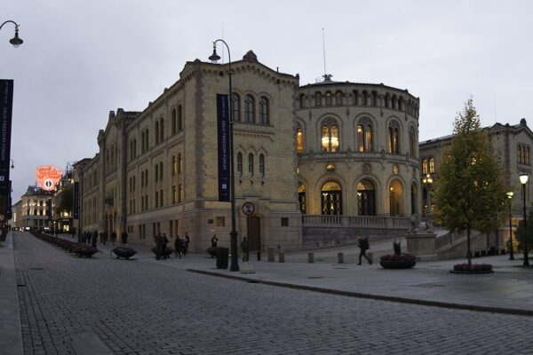 The Storting building in Oslo, seat of the Norwegian parliament, at dusk on a quiet street