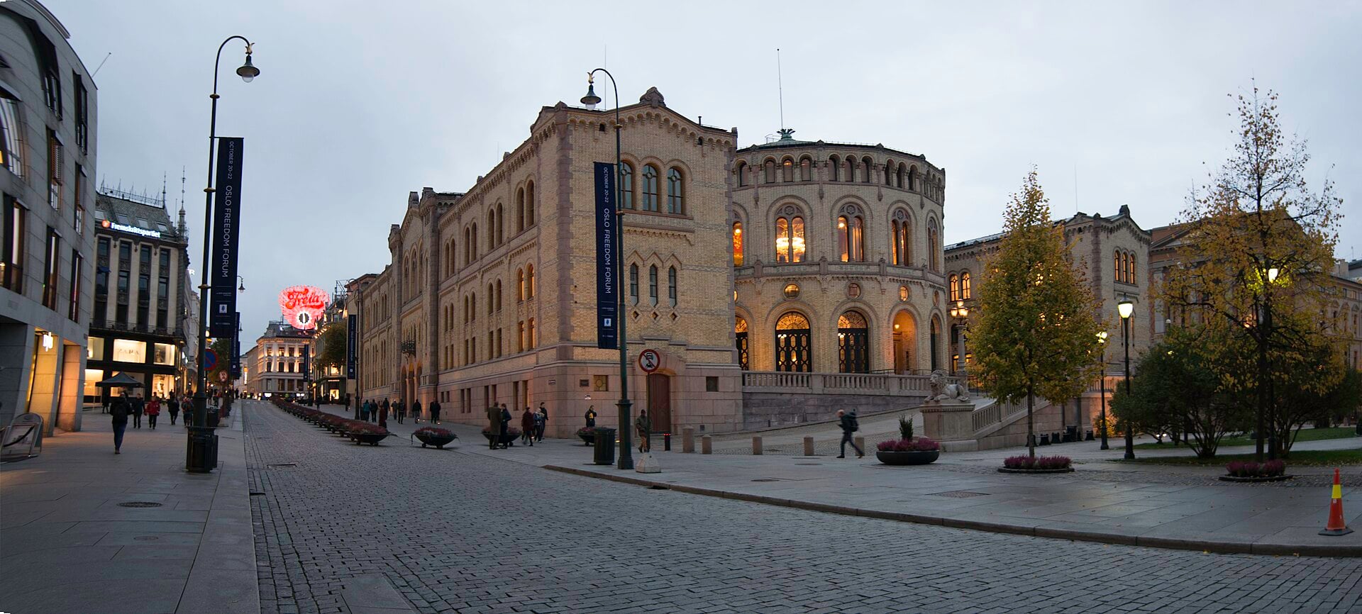 The Storting building in Oslo, seat of the Norwegian parliament, at dusk on a quiet street