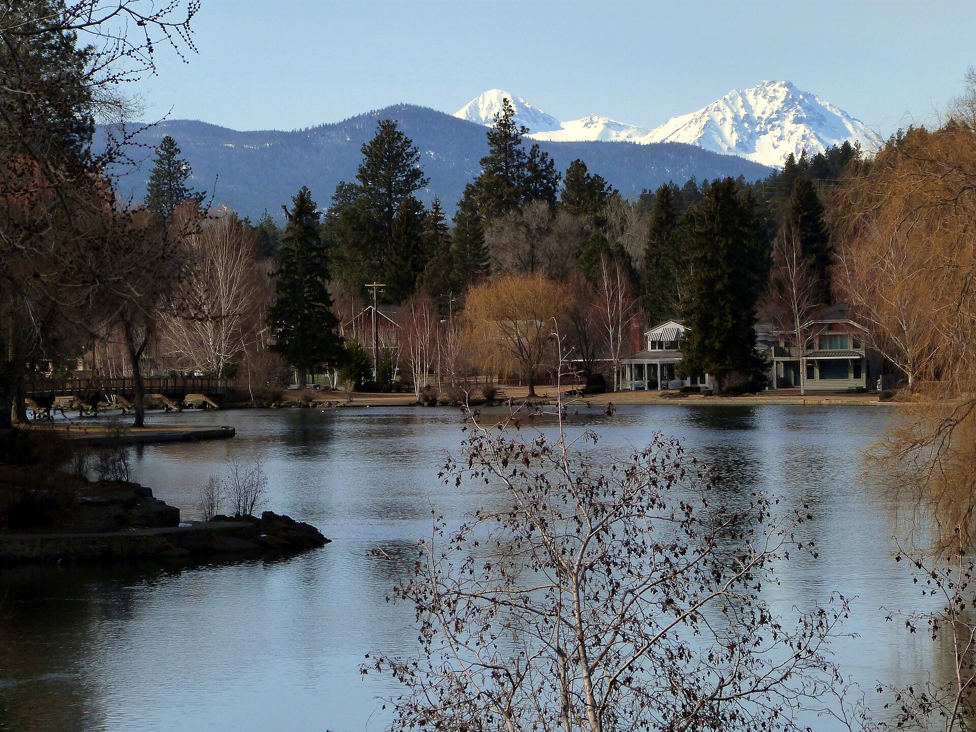 Mirror Pond in Bend, Oregon, with snow-covered Cascade peaks behind