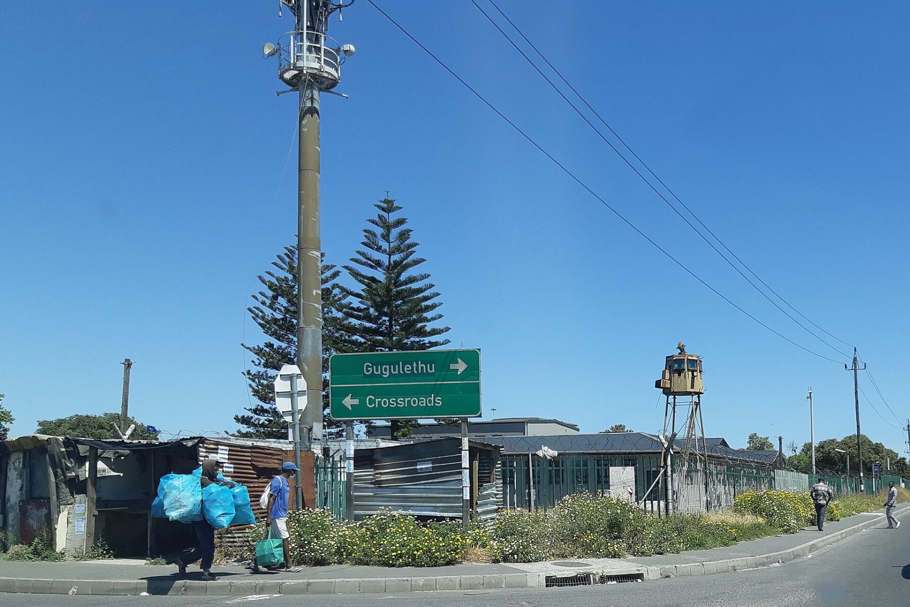 Street corner with road signs to Gugulethu and Crossroads outside the Home Affairs office in Nyanga, Cape Town