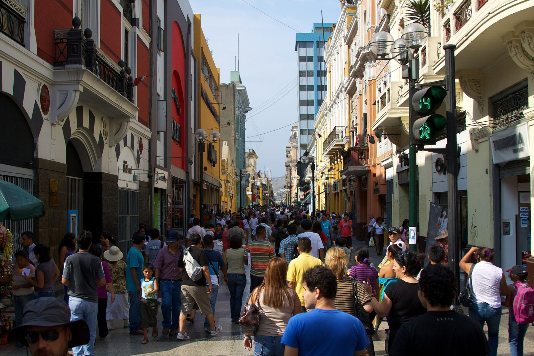 Crowds of pedestrians walking along the Jirón de la Unión shopping street in central Lima between colonial and modern buildings