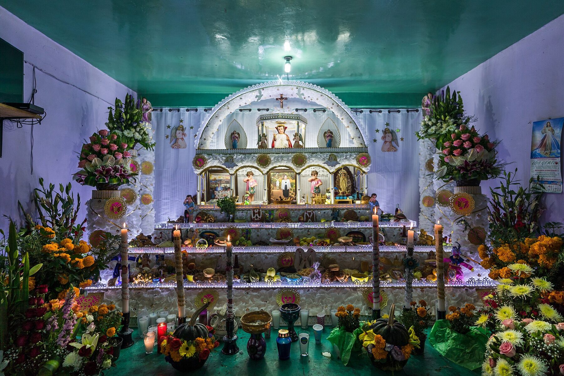 Day of the Dead ofrenda with candles, marigolds and offerings in Puebla, Mexico