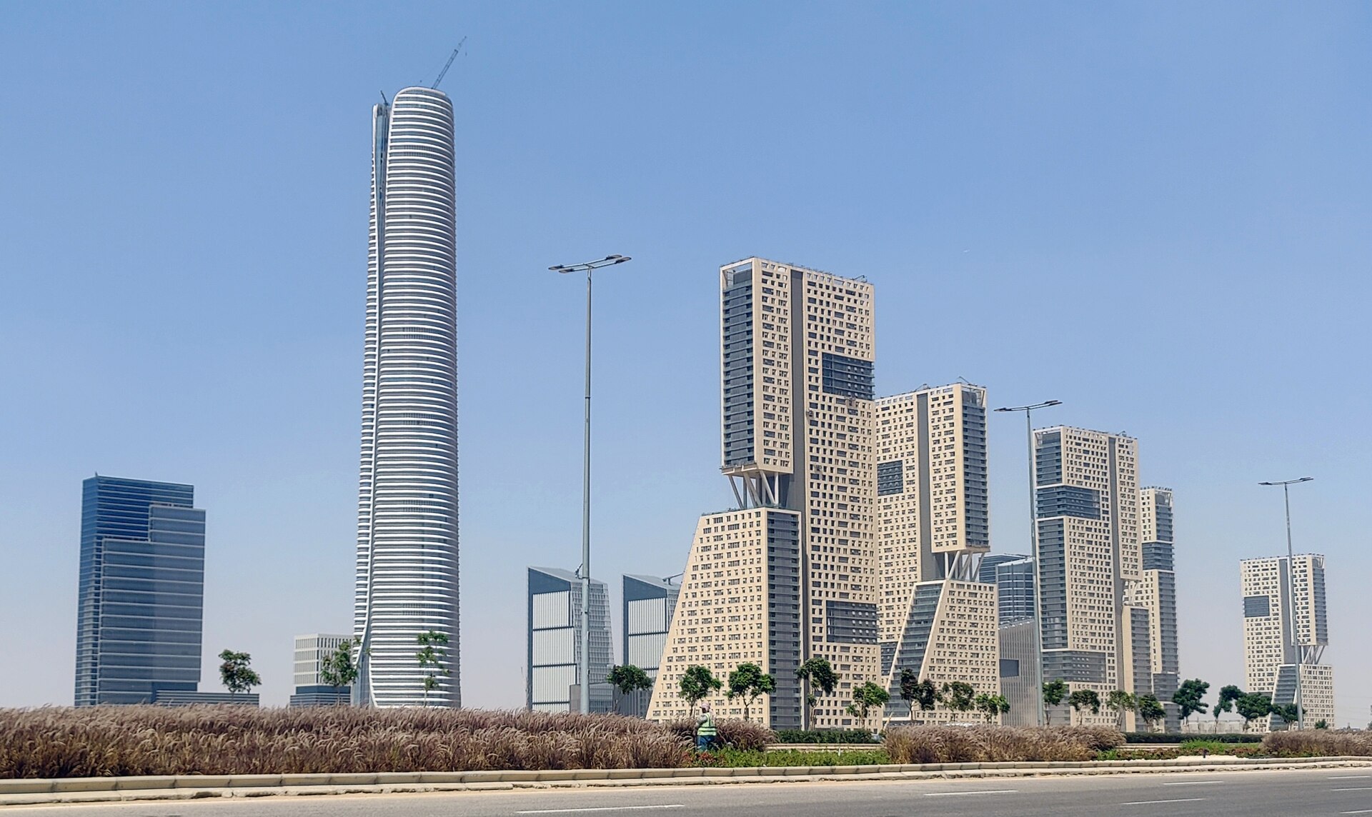 The tall cylindrical Iconic Tower and stepped high-rise buildings in the central business district of Egypt's New Administrative Capital.