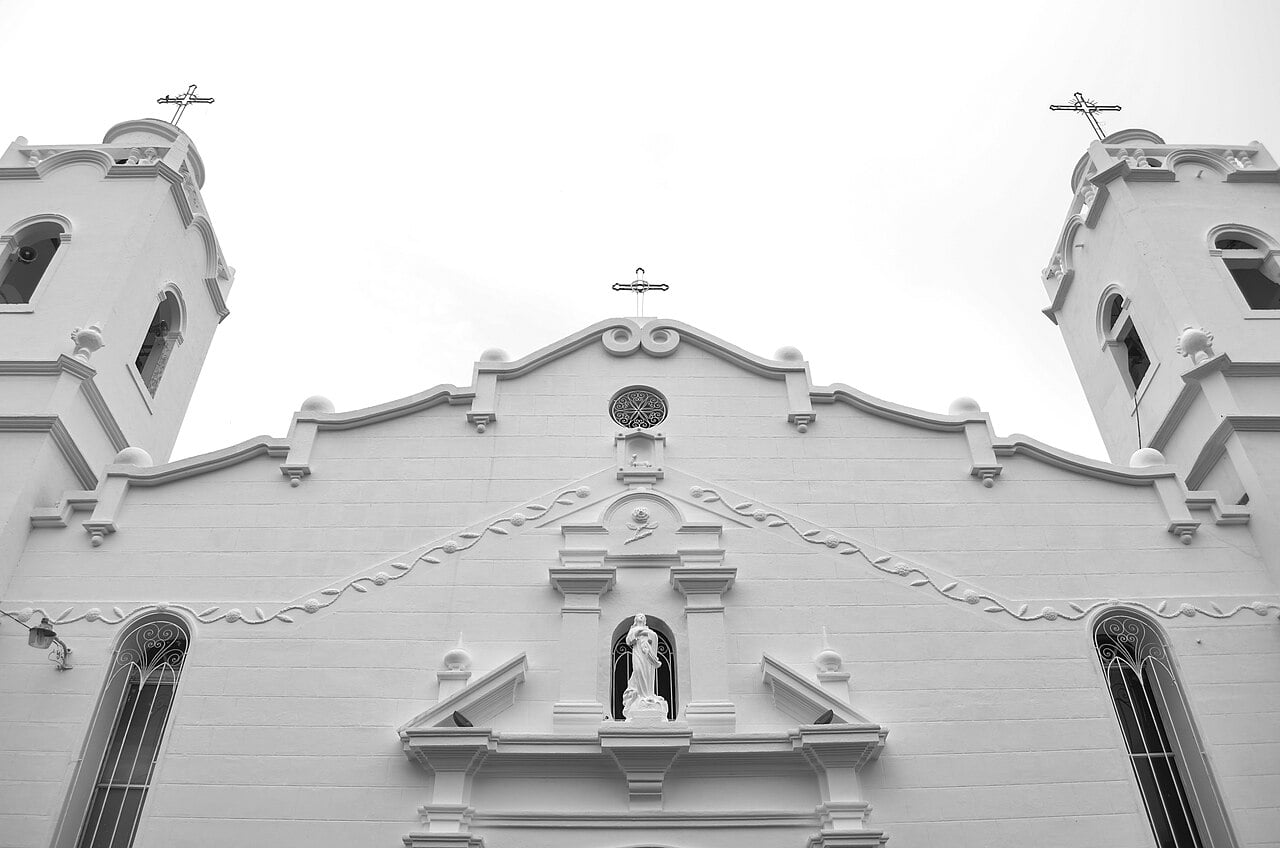 The white facade and two bell towers of the Catedral de San Juan Bautista in Penonomé, Panama, in black and white