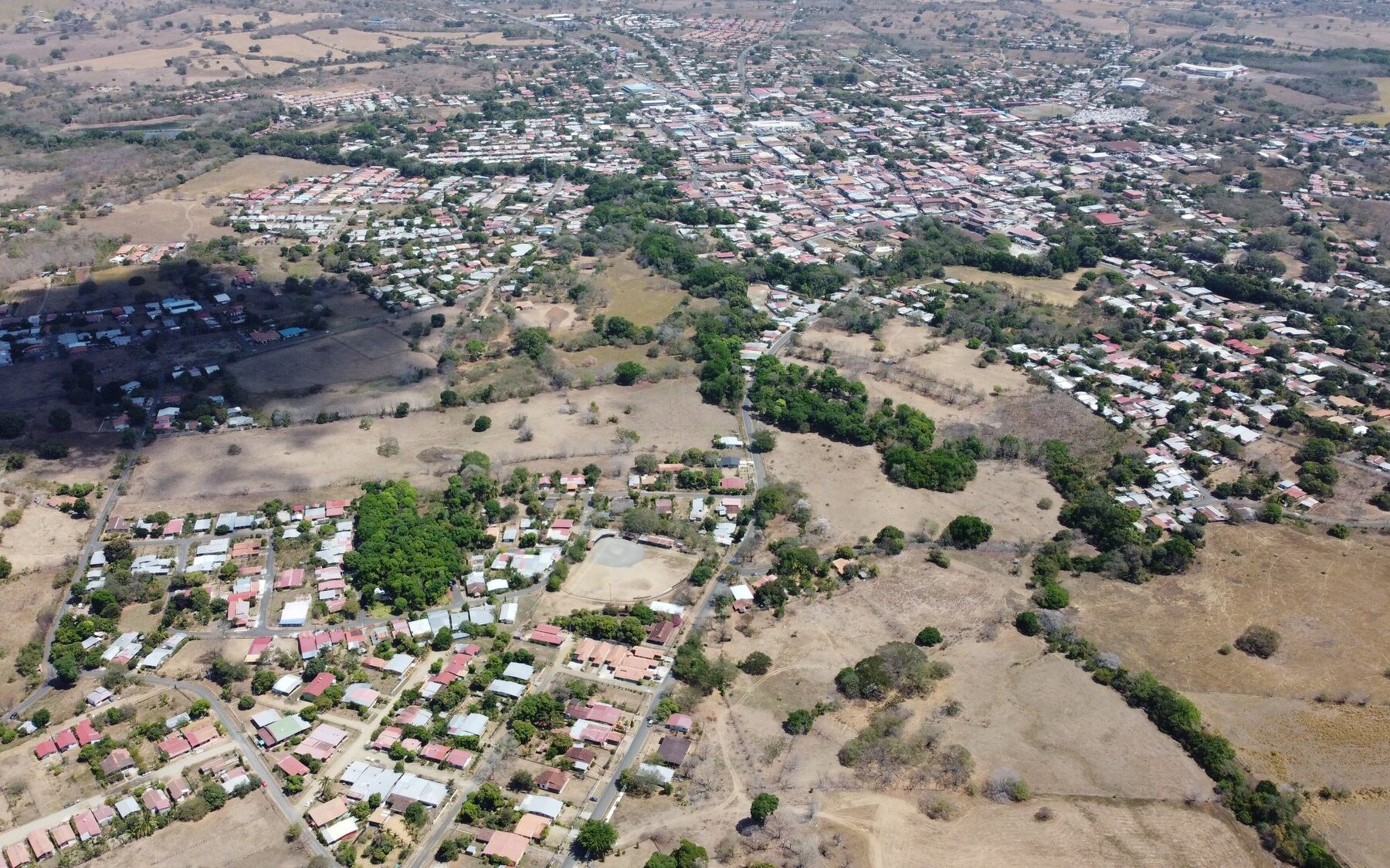 Aerial view of Las Tablas, capital of Los Santos province in Panama, with low houses and dry hills
