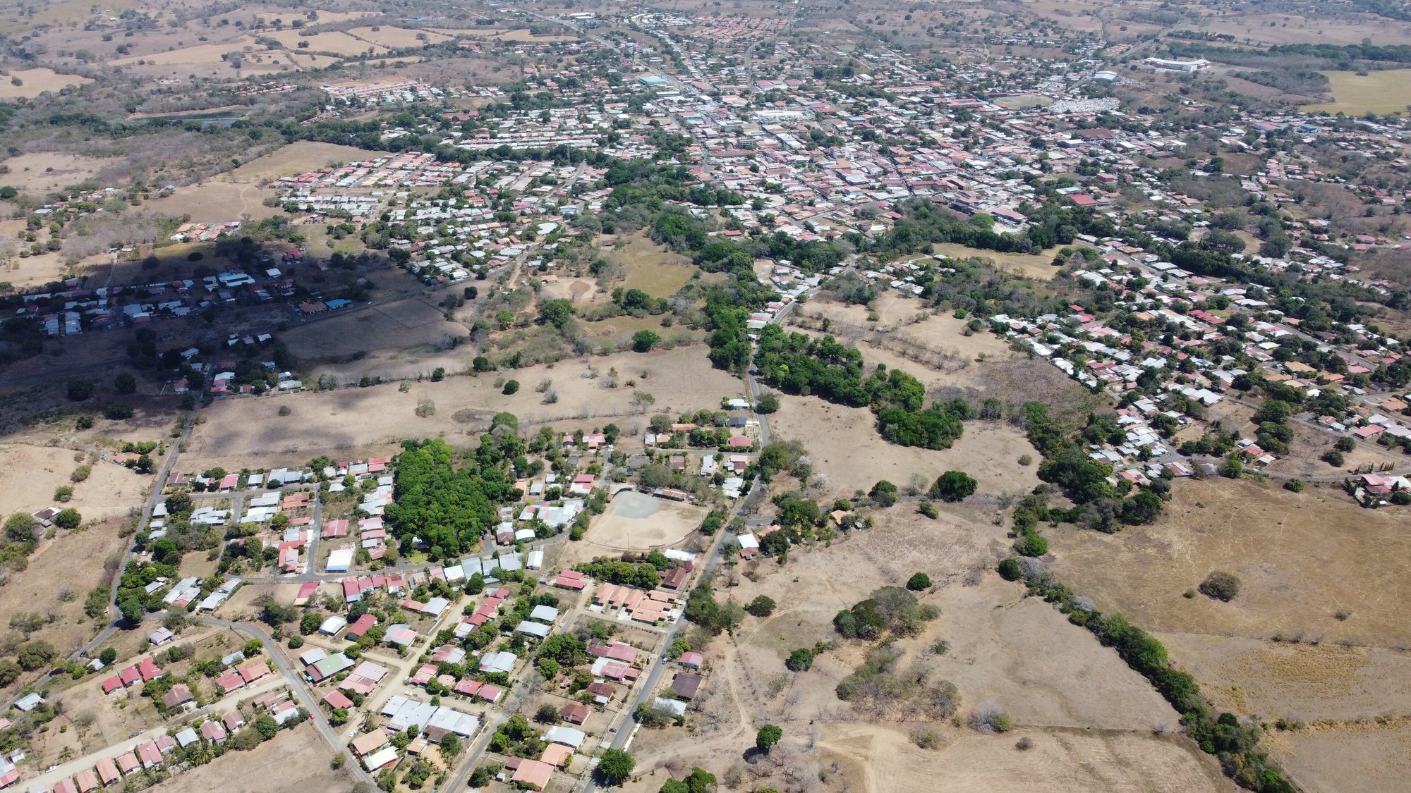 Aerial view of Las Tablas, capital of Los Santos province in Panama, with low houses and dry hills