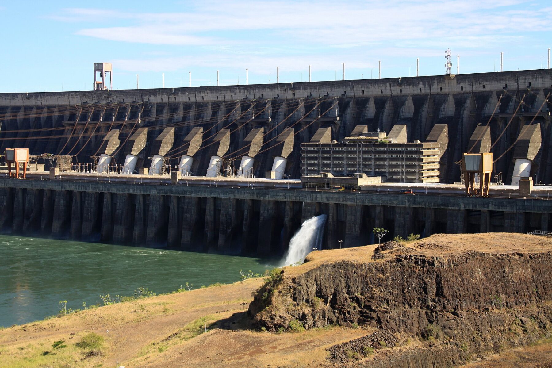 The Itaipú dam powerhouse on the Paraná River, which Paraguay shares with Brazil, with water spilling beside the generating units