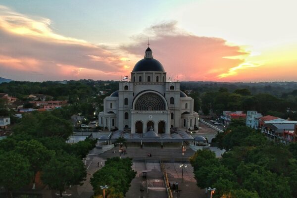The Basilica of Caacupé in Paraguay with its dark dome and wide front steps seen from above at sunset