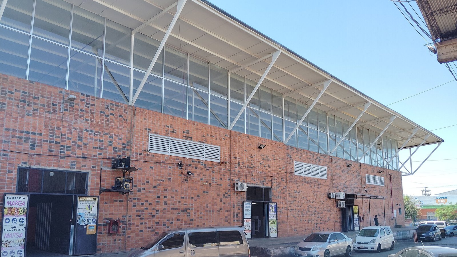 Paraguay inflation: the brick-and-glass Block C of the Mercado de Abasto, the wholesale food market of Asunción, with a fruit shop at the entrance