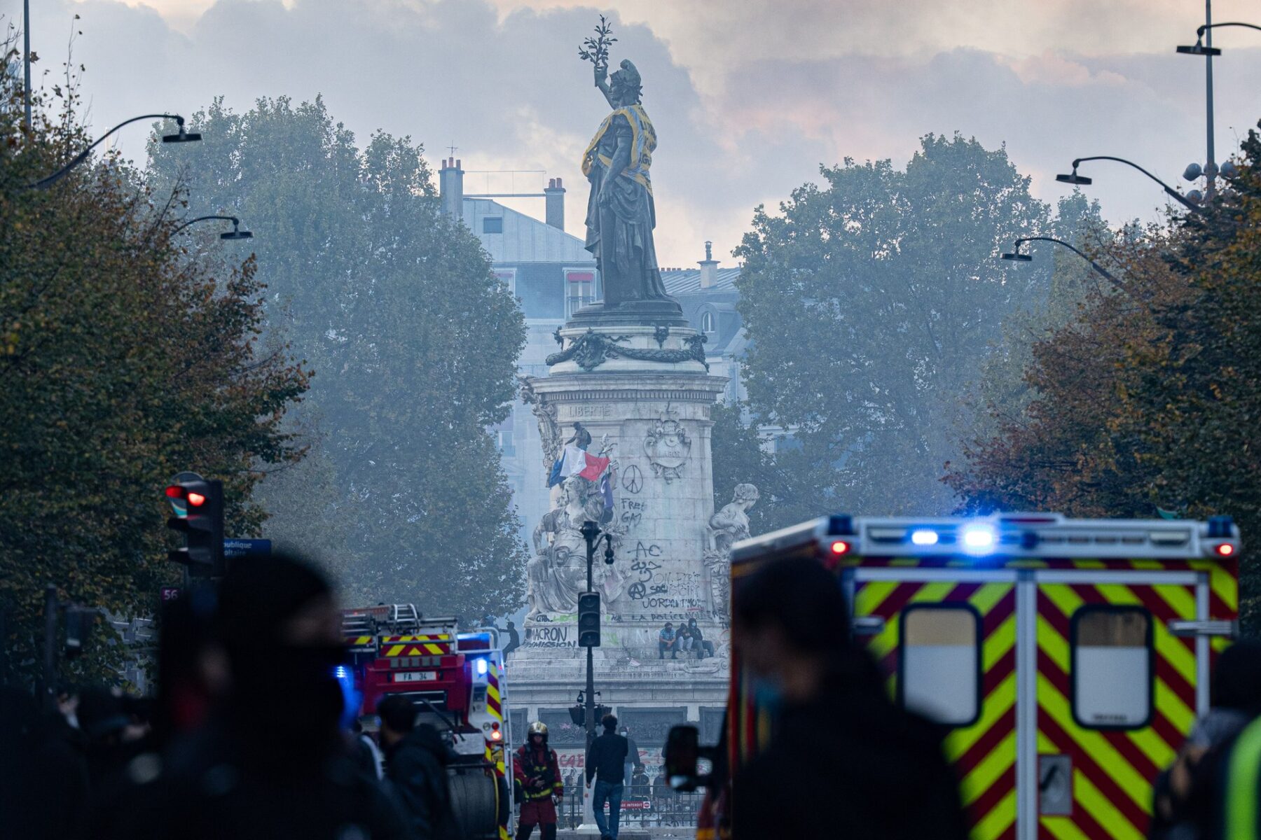 Fire brigade vehicles with flashing lights near the Place de la République statue in Paris on 17 October 2026