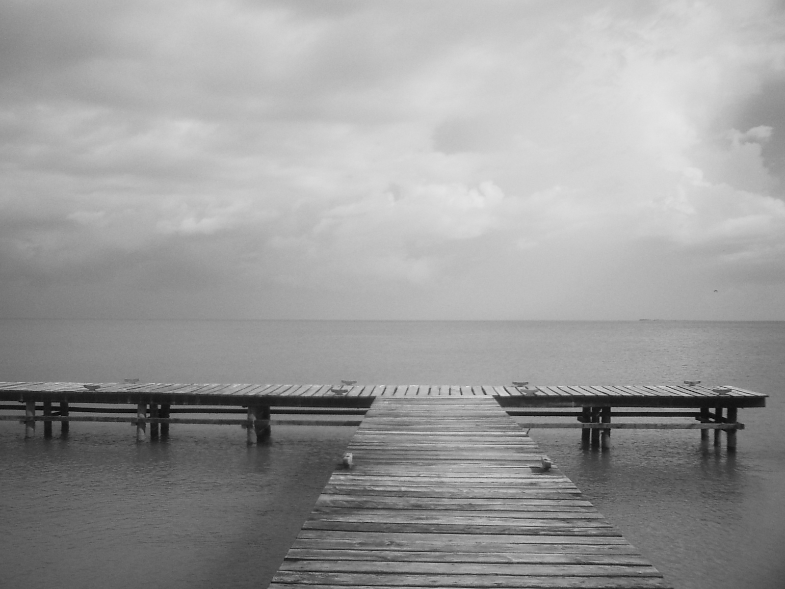 Wooden pier extending into calm water at Ciudad del Carmen, Campeche