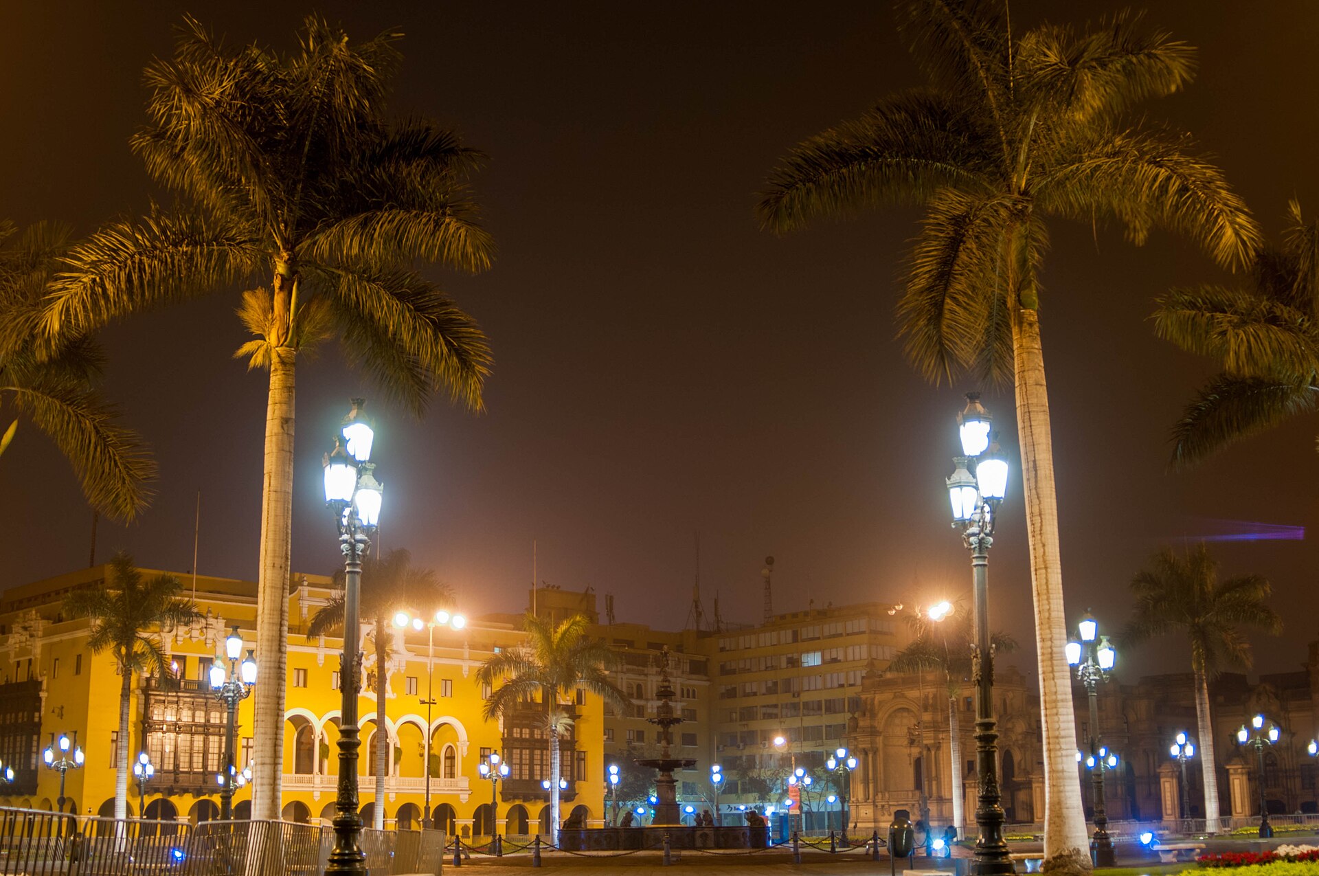 Plaza Mayor of Lima, Peru, lit at night with palm trees