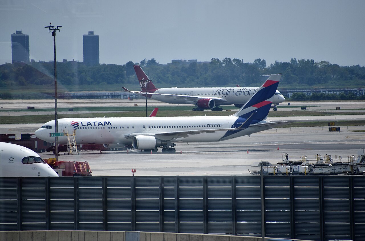 A LATAM Airlines Boeing 767 on the tarmac at New York John F. Kennedy International Airport, with a Virgin Atlantic jet behind it