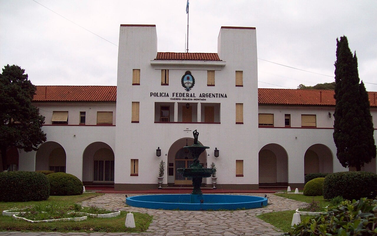 White two-storey building with arches, a fountain and the sign Policía Federal Argentina, home of the force's mounted police unit in Buenos Aires