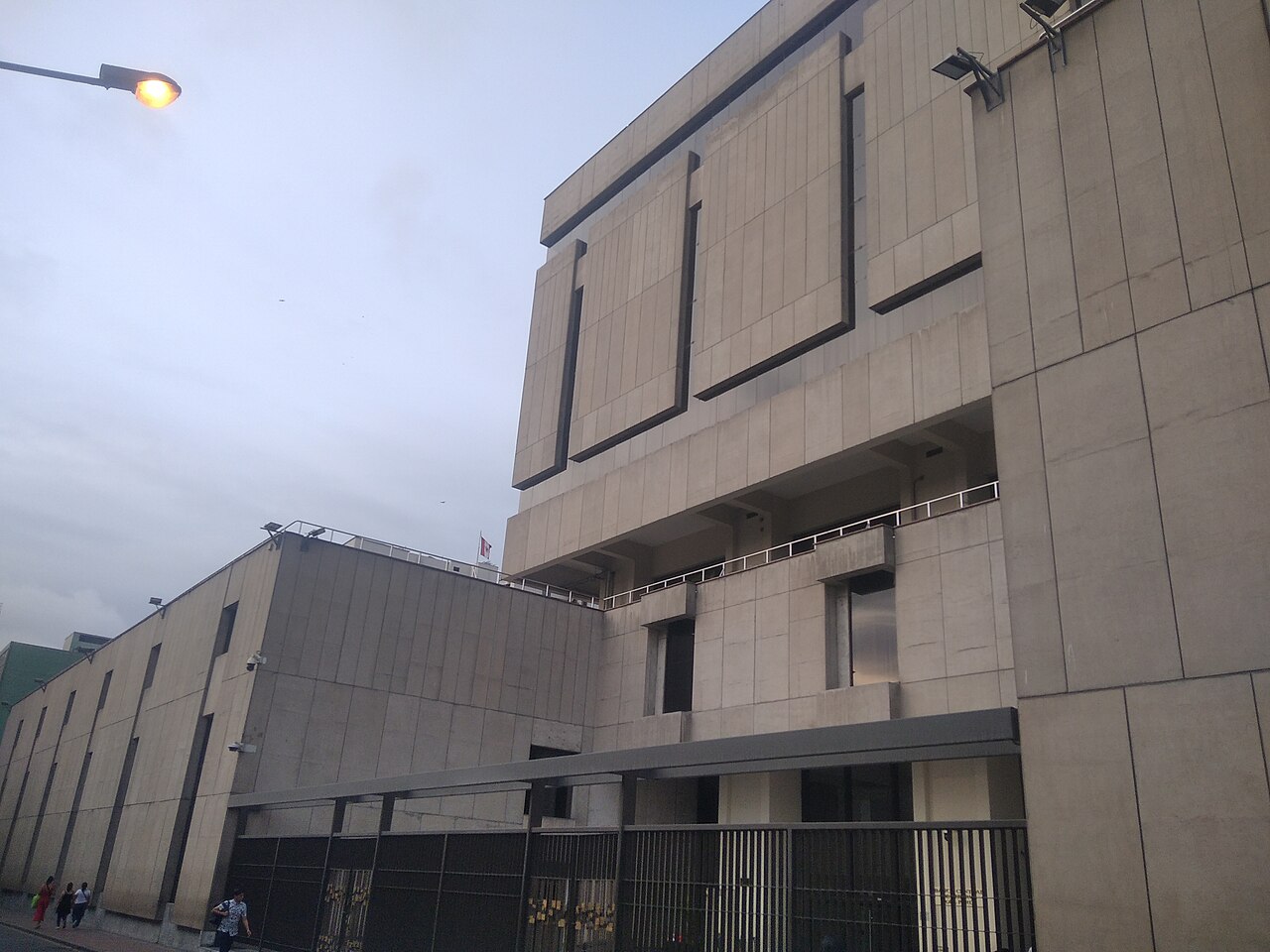 Concrete headquarters of Peru central bank, the BCRP, on a street in central Lima at dusk