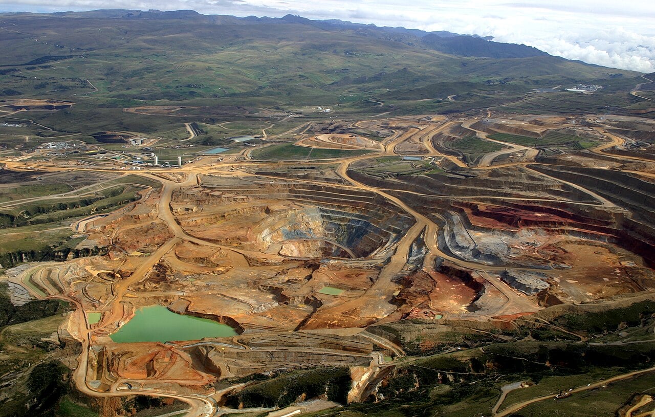 Aerial view of large open pits, haul roads and green ponds at the Yanacocha gold mine in the highlands of northern Peru