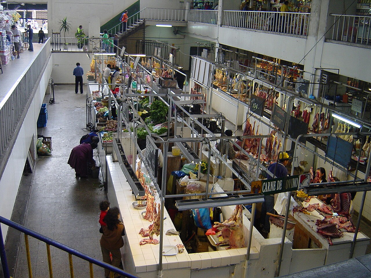 Stalls with vegetables, poultry and meat inside the Mercado Central market hall in Lima, seen from an upper floor