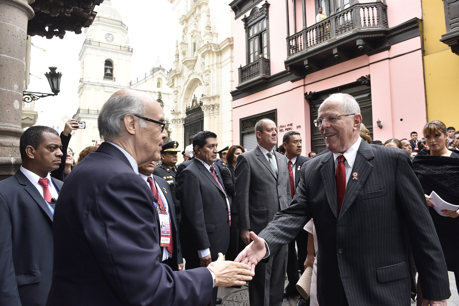 Pedro Pablo Kuczynski in a pinstripe suit shaking hands outside Torre Tagle Palace in Lima
