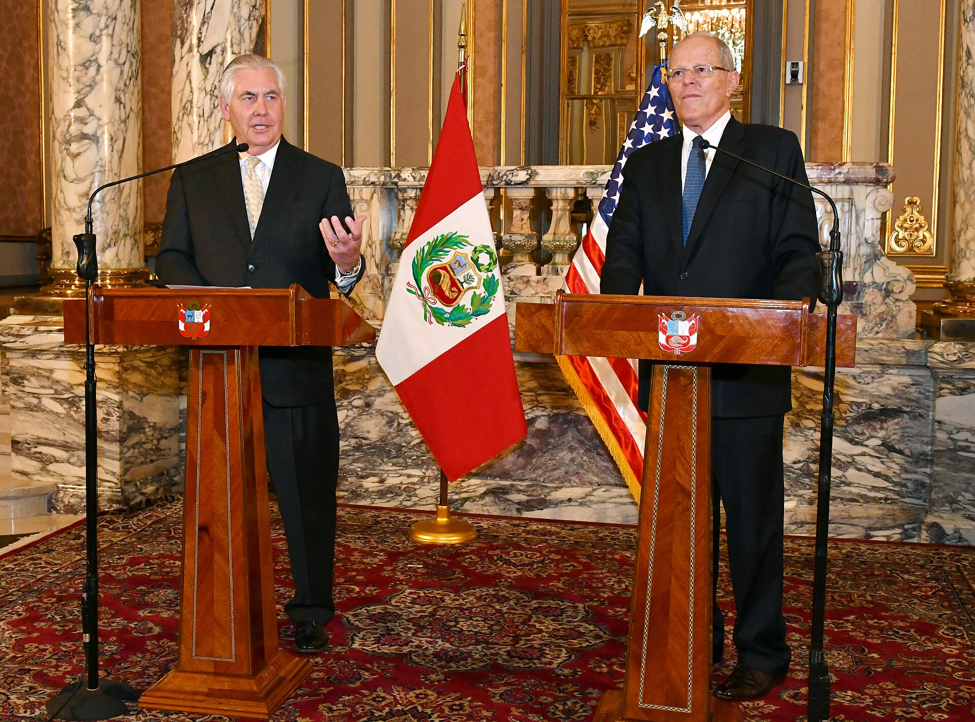 Rex Tillerson and Pedro Pablo Kuczynski at lecterns beside Peruvian and US flags in Lima