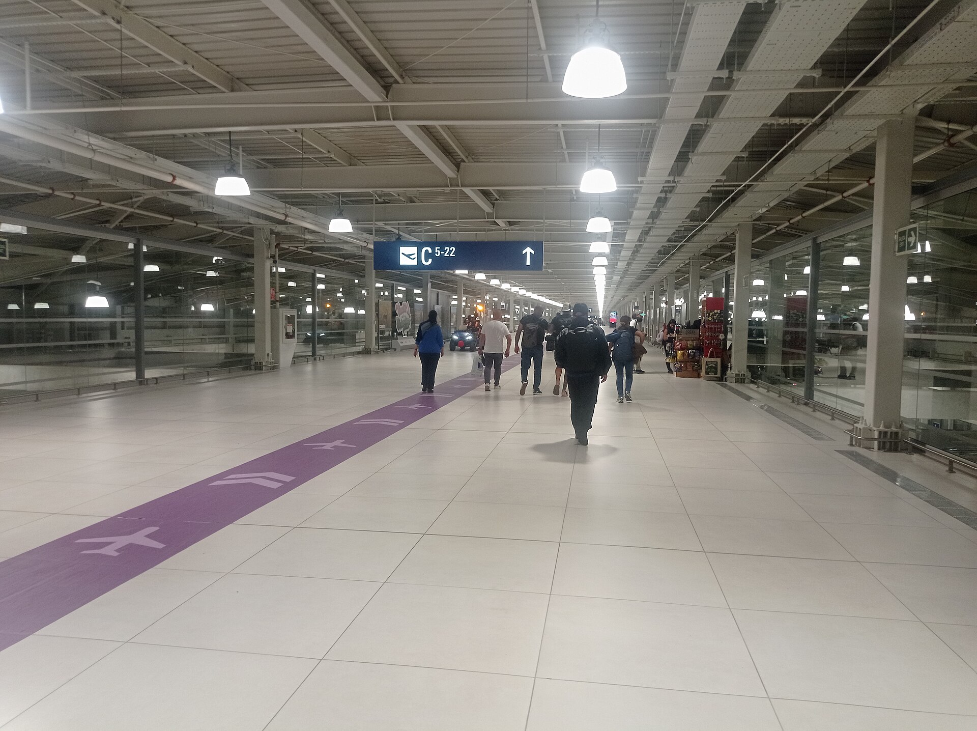 Passengers walk towards departure gates at Jorge Chavez International Airport in Lima