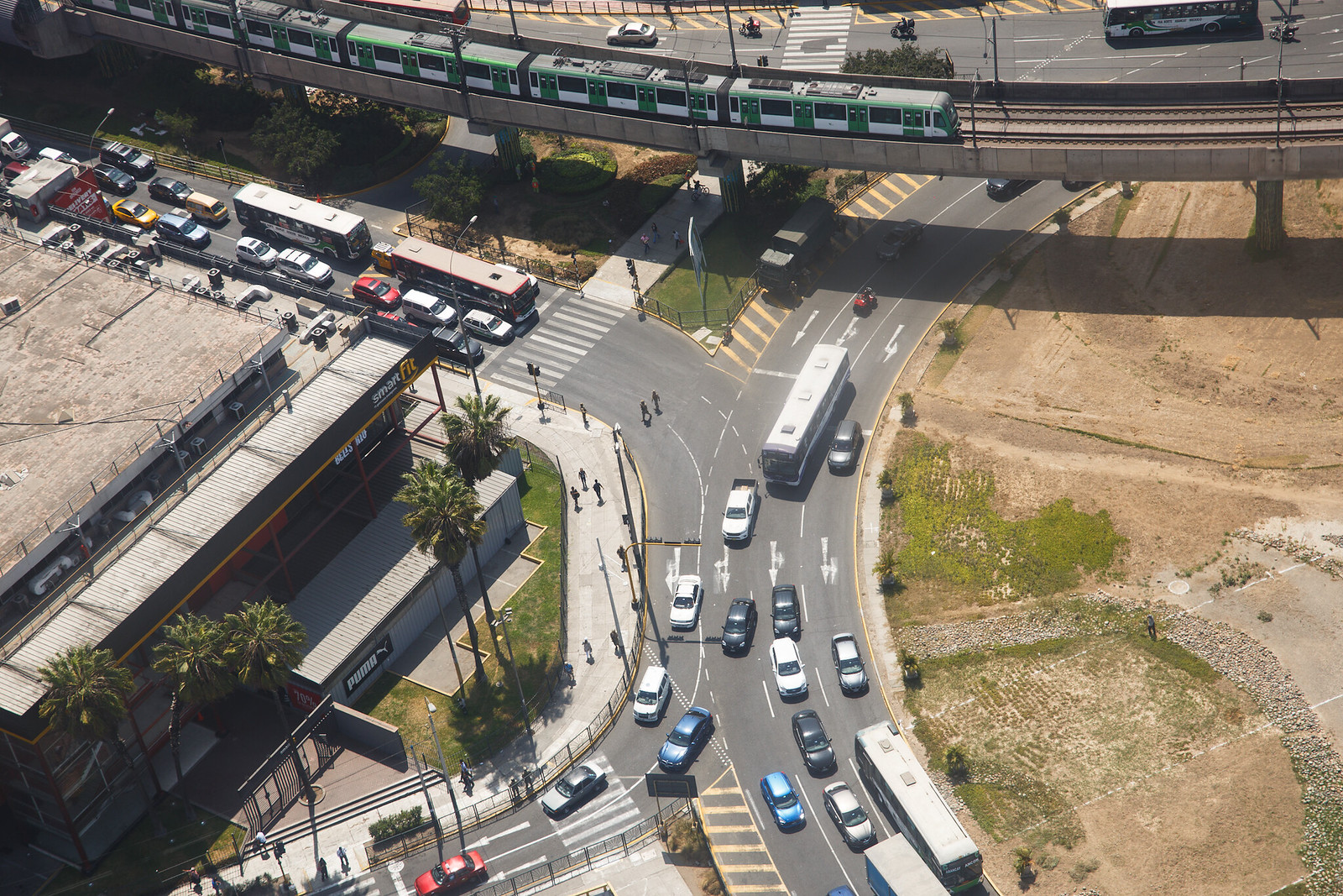 Aerial view of a Lima junction beside Metro Line 1 with a military truck parked by the road