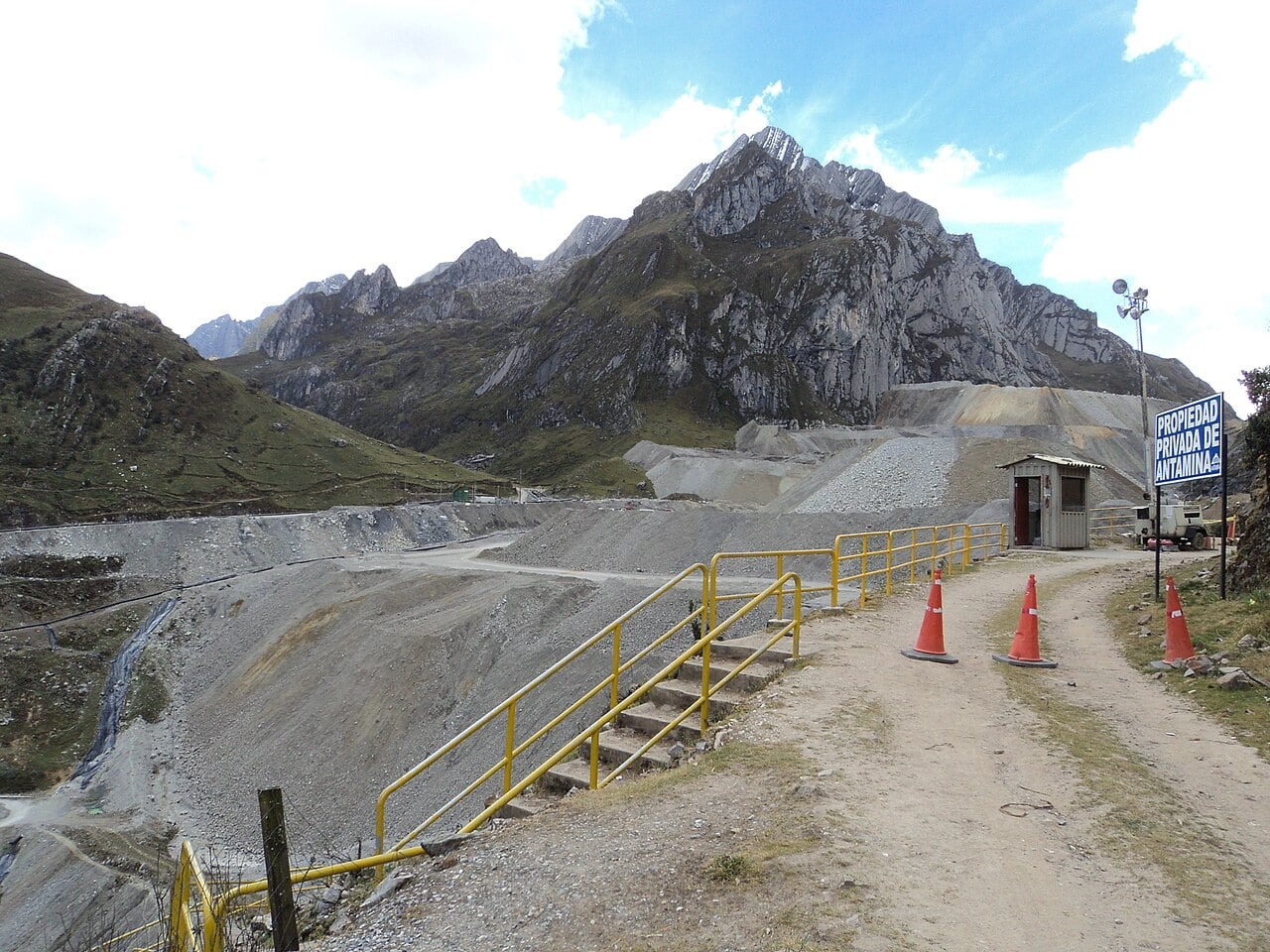 Waste rock dump and access road at the Antamina copper and zinc mine below rocky Andean peaks in Peru