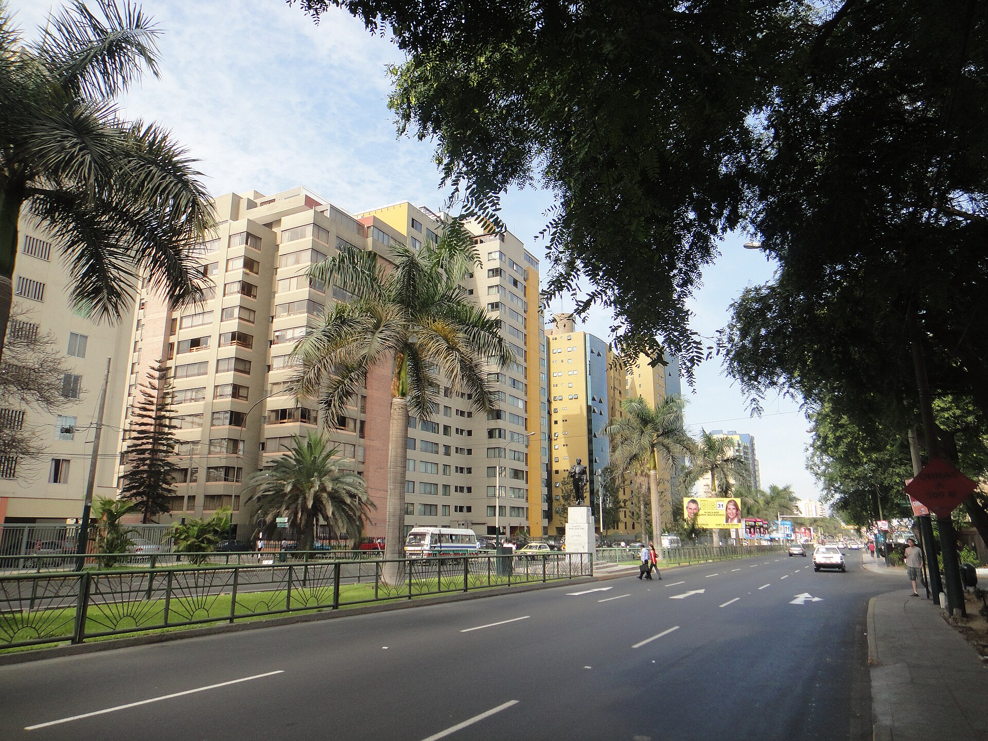 Javier Prado Avenue in San Isidro, Lima, with apartment towers and a statue